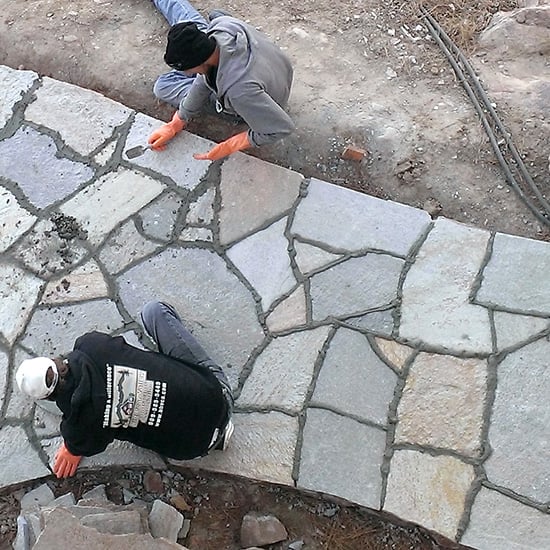 grouting the joints in a natural stone-paved walkway